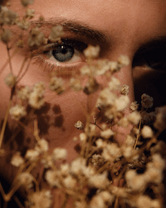 Woman face behind herbs